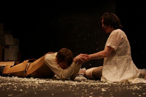 A young man collapsed on the ground,
clasping his sister's hand
