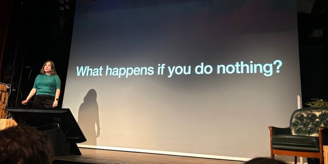 Sophie in front of a slide that asks what happens if you do nothing?
