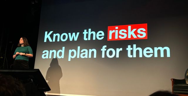 Sophie in front of a slide that says know the risks and plan for them
